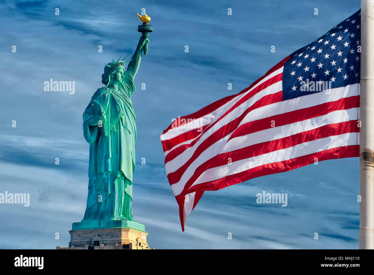 Usa American flag stars and stripes on statue of liberty blue sky background Stock Photo