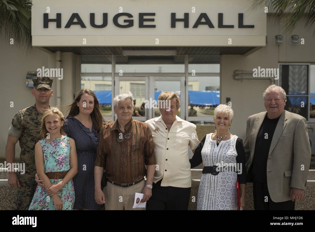 'We are very honored to know that he is not forgotten, and to know the Marines remember him, ' said Joe Braunschweig, center, nephew of Medal of Honor recipient Cpl. Louis J. Hauge, Jr. Combat Logistics Regiment 35, 3rd Marine Logistics Group, dedicated their headquarters building in memory of Hauge for his heroic actions during the Battle of Okinawa, April 30, 2018 on Camp Kinser, Okinawa, Japan, April 30, 2018. Braunschweig is a native of Browns point, Washington. (U.S. Marine Corps photo by Lance Cpl. Jamin M. Powell). () Stock Photo