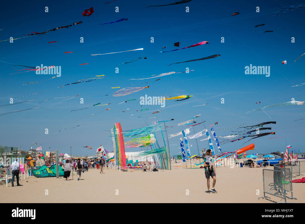 Many colorful kites in different shapes on the beach at Cervia international kite festival 'Artevento' 2018. Stock Photo