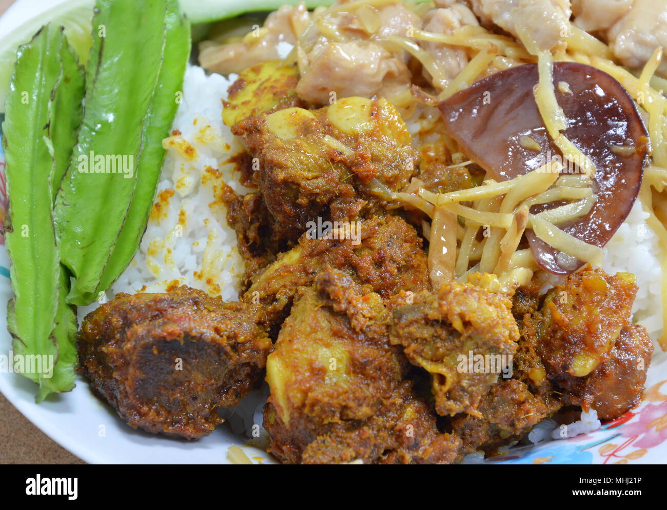 stir-fried chicken with slice ginger and black mushroom on rice Stock