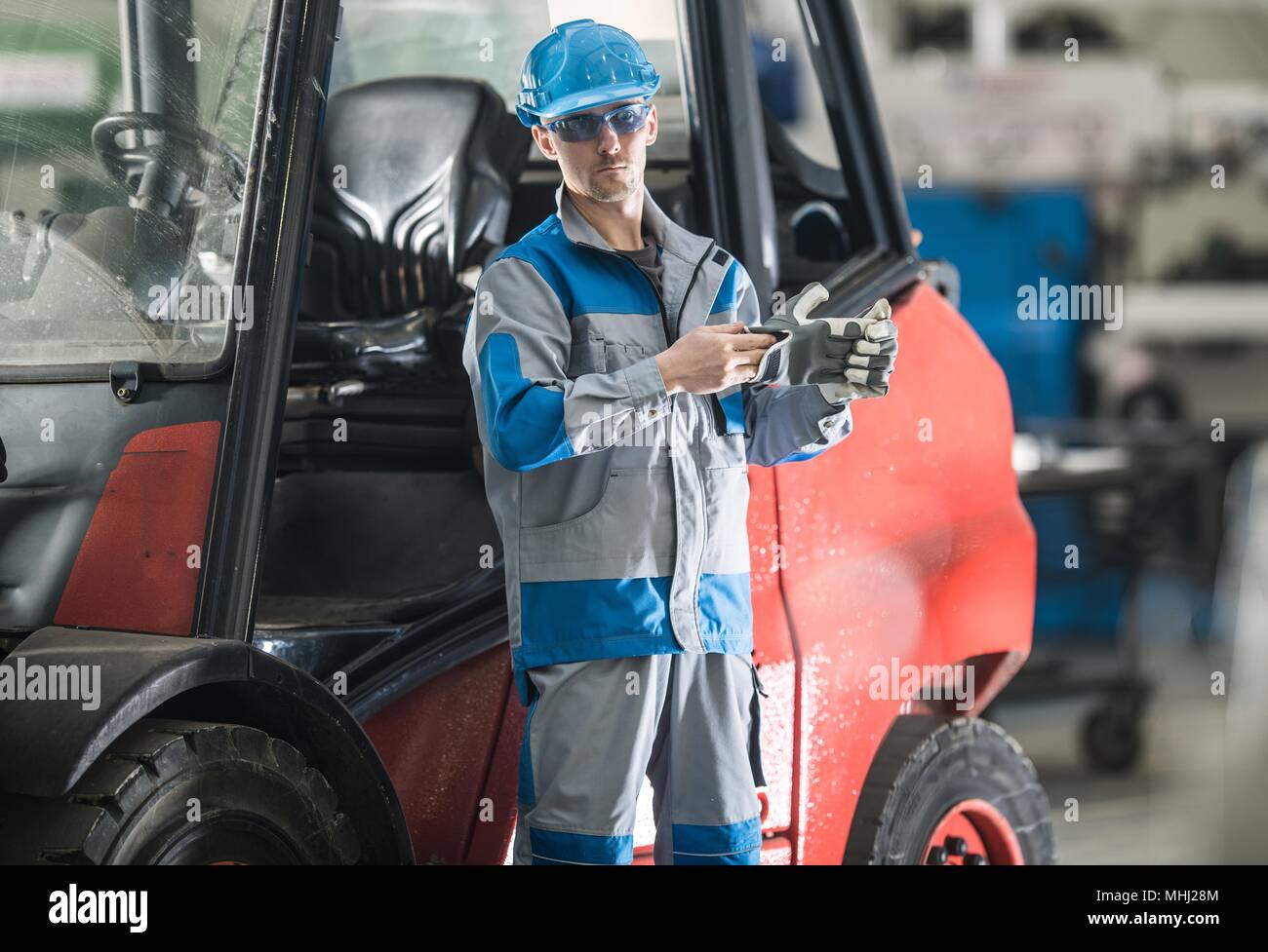 Forklift Truck Operating By Caucasian Factory Worker In His 30s Wearing Safety Hard Hat And Glasses Stock Photo Alamy