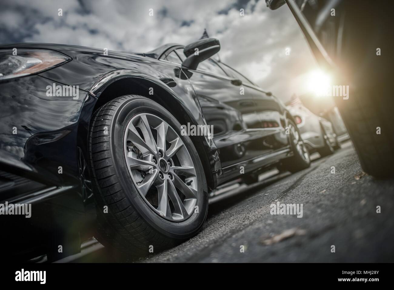 Full Cars Parking. Modern Vehicle Closeup from Low Ground Level. Stock Photo