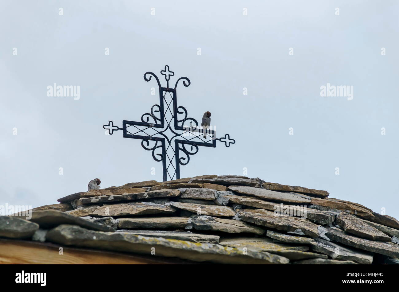 Stone roof with metal cross in monastery 'Sv. Sv. Cosmas and Damian', Bulgaria Stock Photo