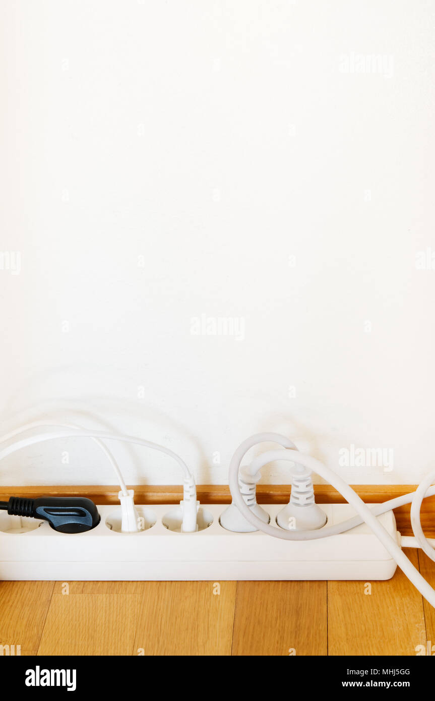 Multiple socket outlet on wooden floor Stock Photo Alamy