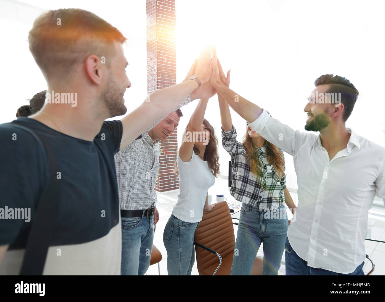 creative team giving each other a high five Stock Photo - Alamy