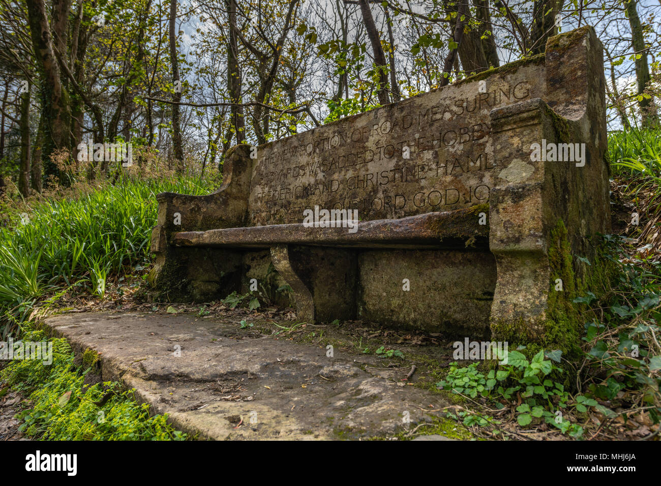 A commemorative stone seat on the Hobby Walk, part of the Clovelly Estate, celebrates the opening of a new 833yard stretch of the path in 1901 which i Stock Photo