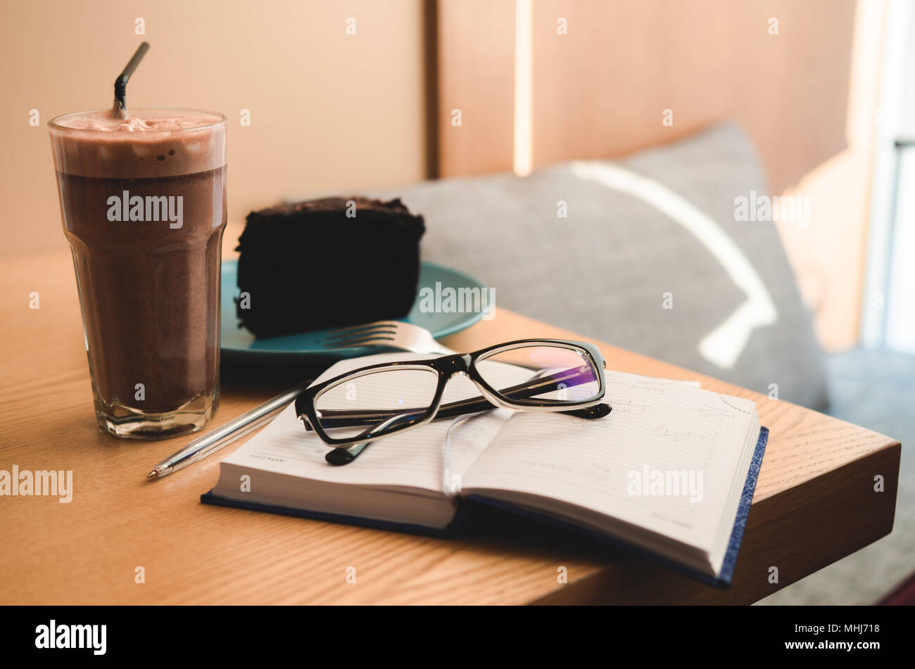Still life: notebook with glasses, cake and coffee. Working or planning concept Stock Photo