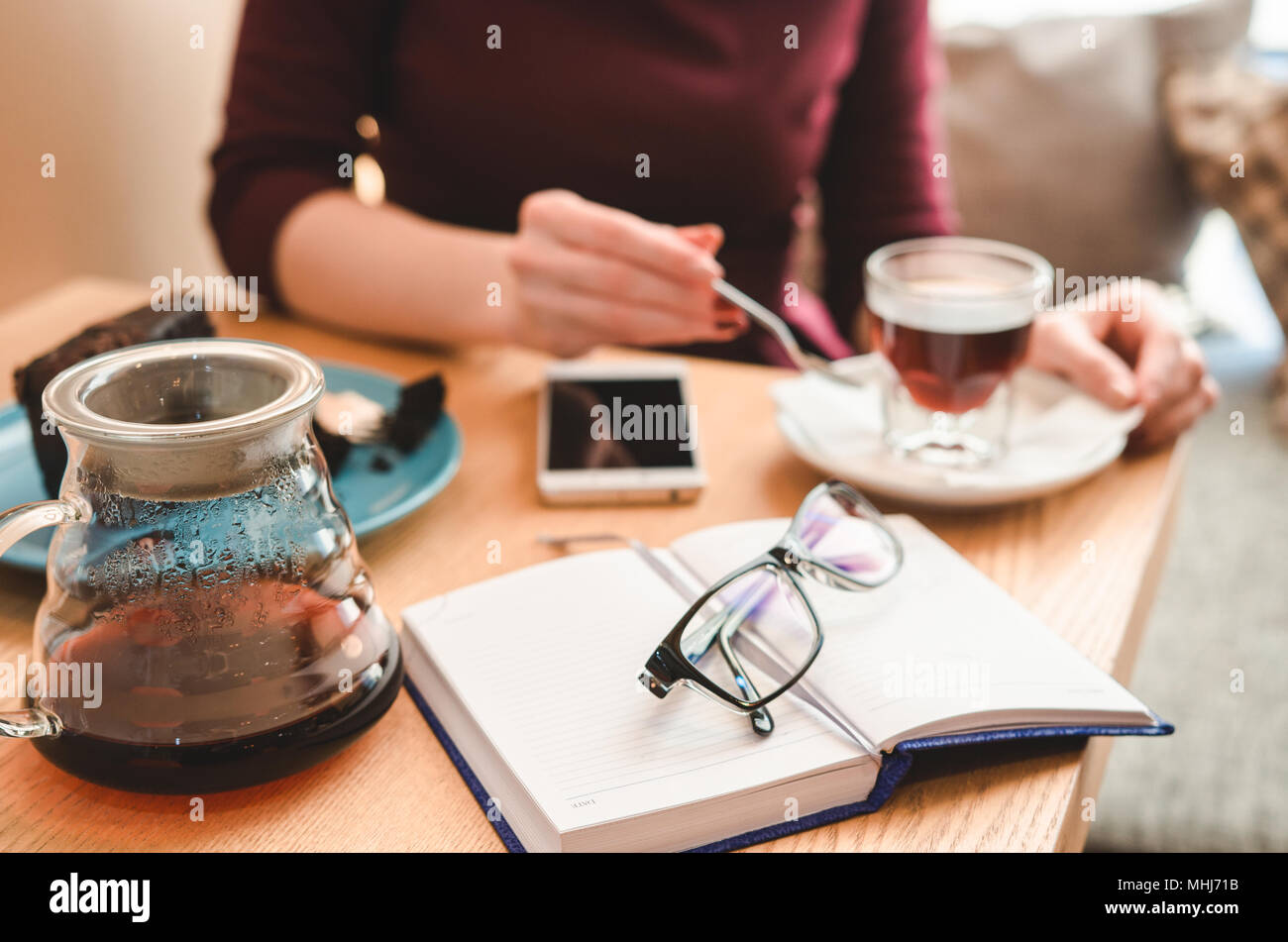 Business lunch concept. Still life: glasses, diary, smartphone and coffee.  Lifestyle soft image Stock Photo
