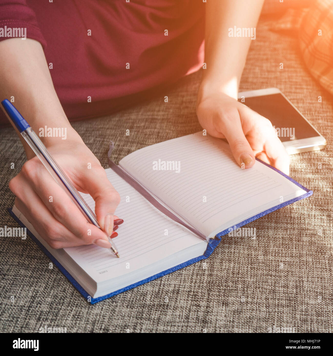 Close up hands woman writing in her notebook. Working or planning concept Stock Photo