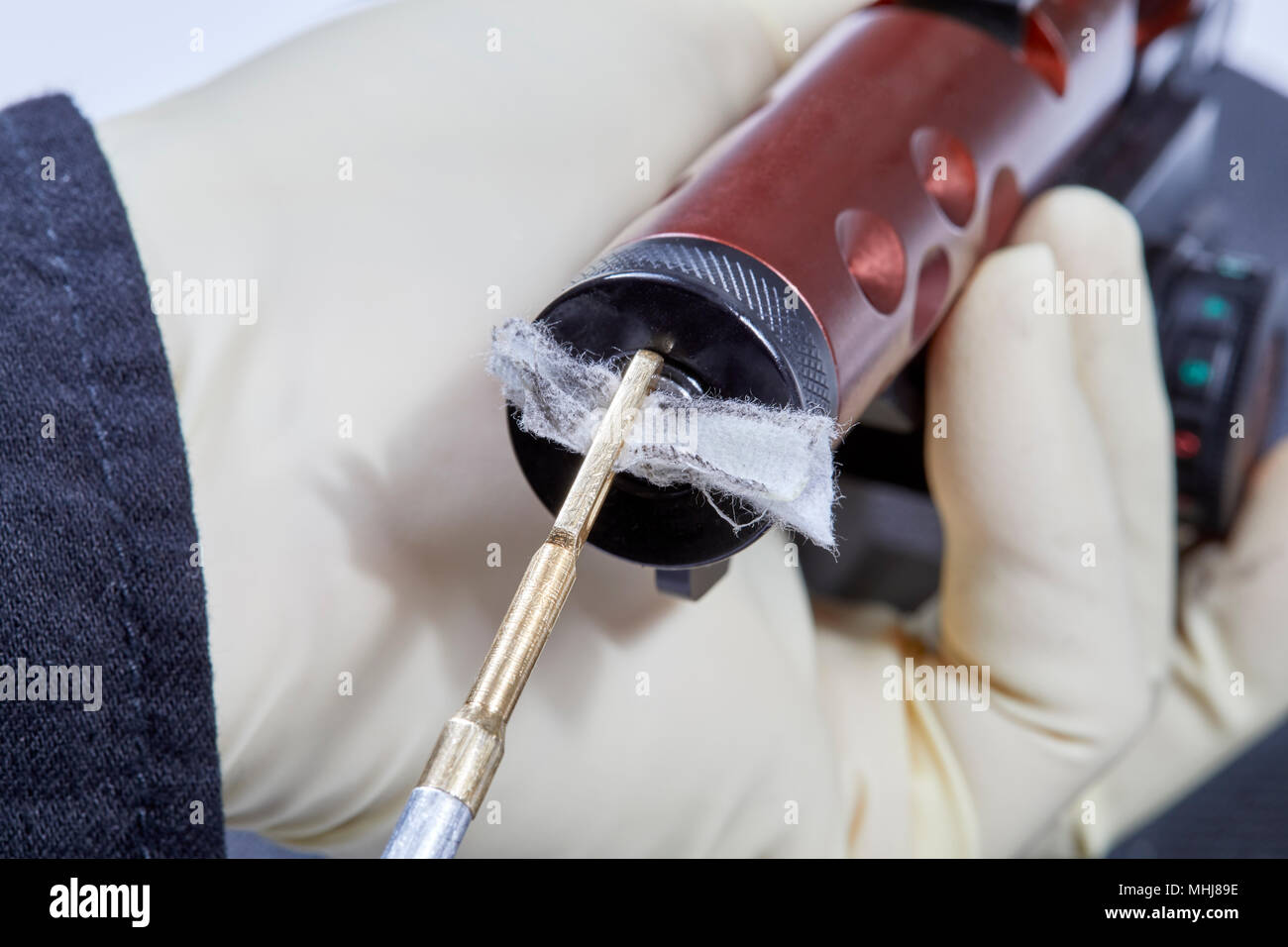 Using a cleanng rod and cotton patch with to clean the barrel of a 22