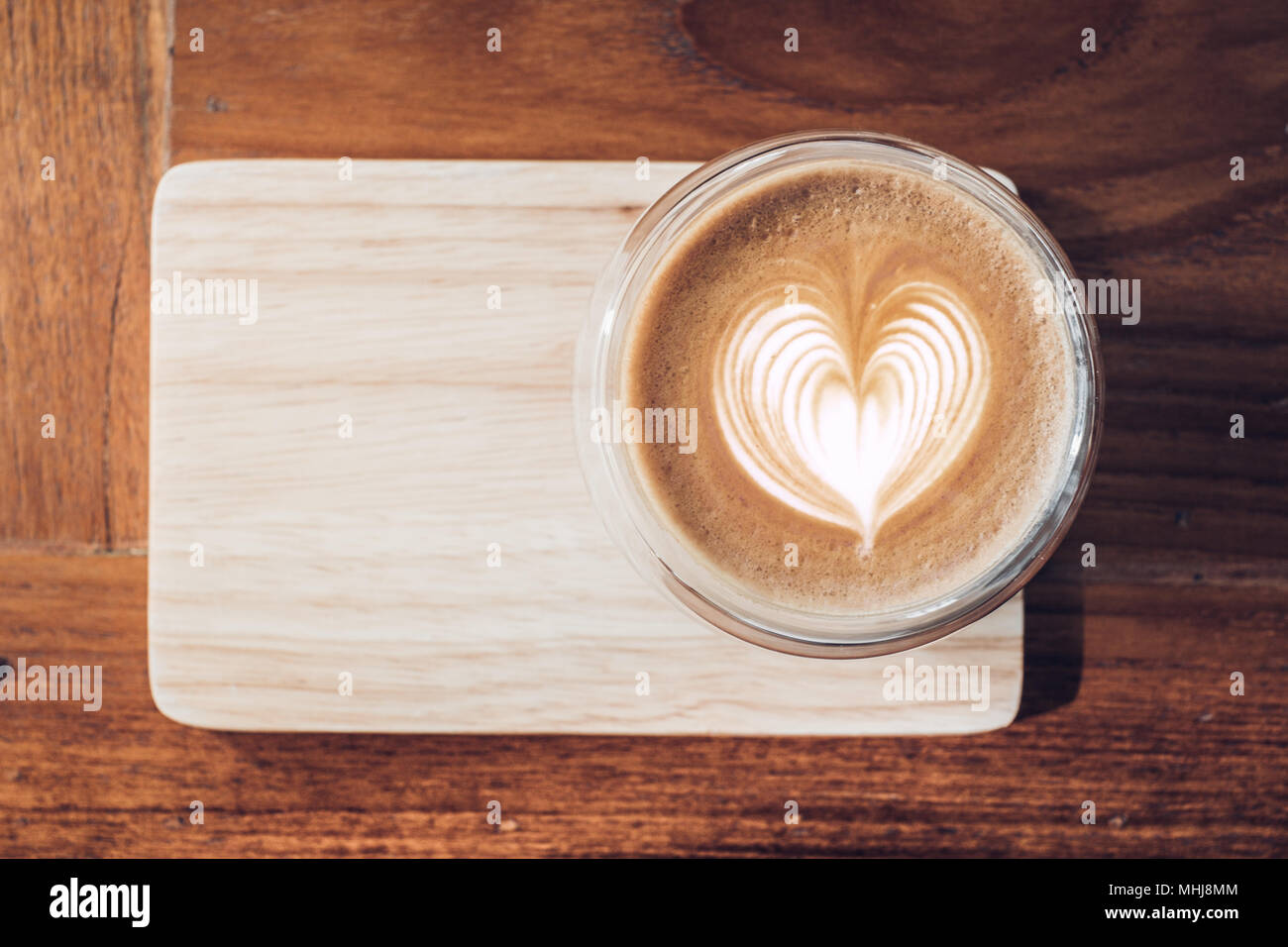 Top view of hot cappuccino coffee cup on wooden tray with heart shape latte art on wood table at cafe,food and drink Stock Photo