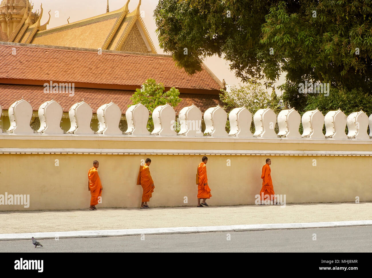 Monks walking outside Royal Palace, Phnom Penh city, Cambodia Stock Photo