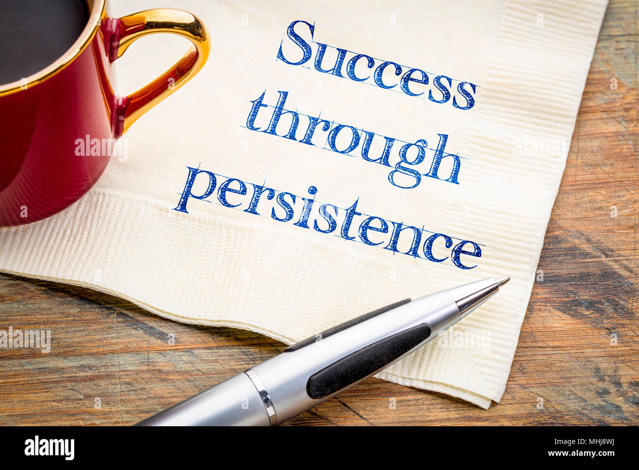Success through persistence - inspirational handwriting on a napkin with a cup of coffee Stock Photo