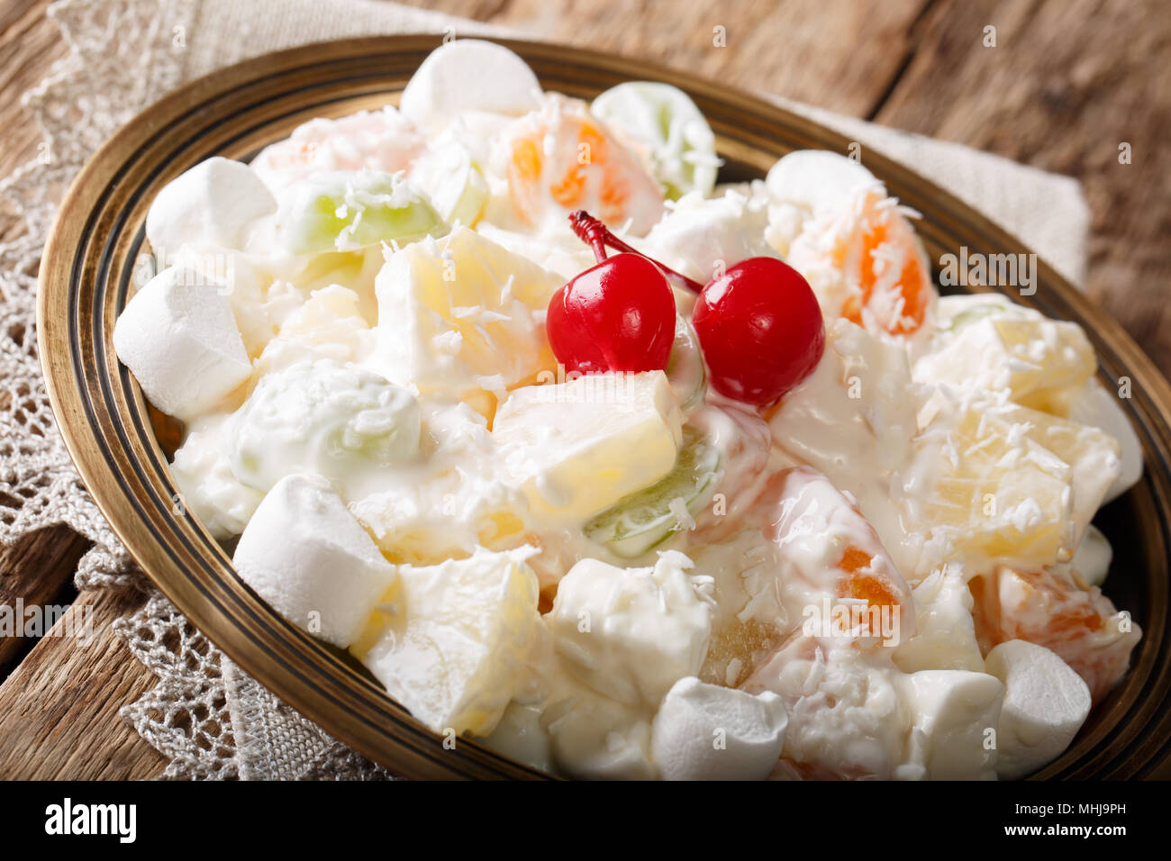 Light fruit salad Ambrosia with marshmallow and vanilla yogurt close-up on a plate. horizontal Stock Photo