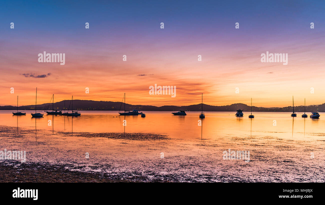 Boats on the Bay - Capturing the sunrise from Koolewong Foreshore on the Central Coast, NSW, Australia. Stock Photo