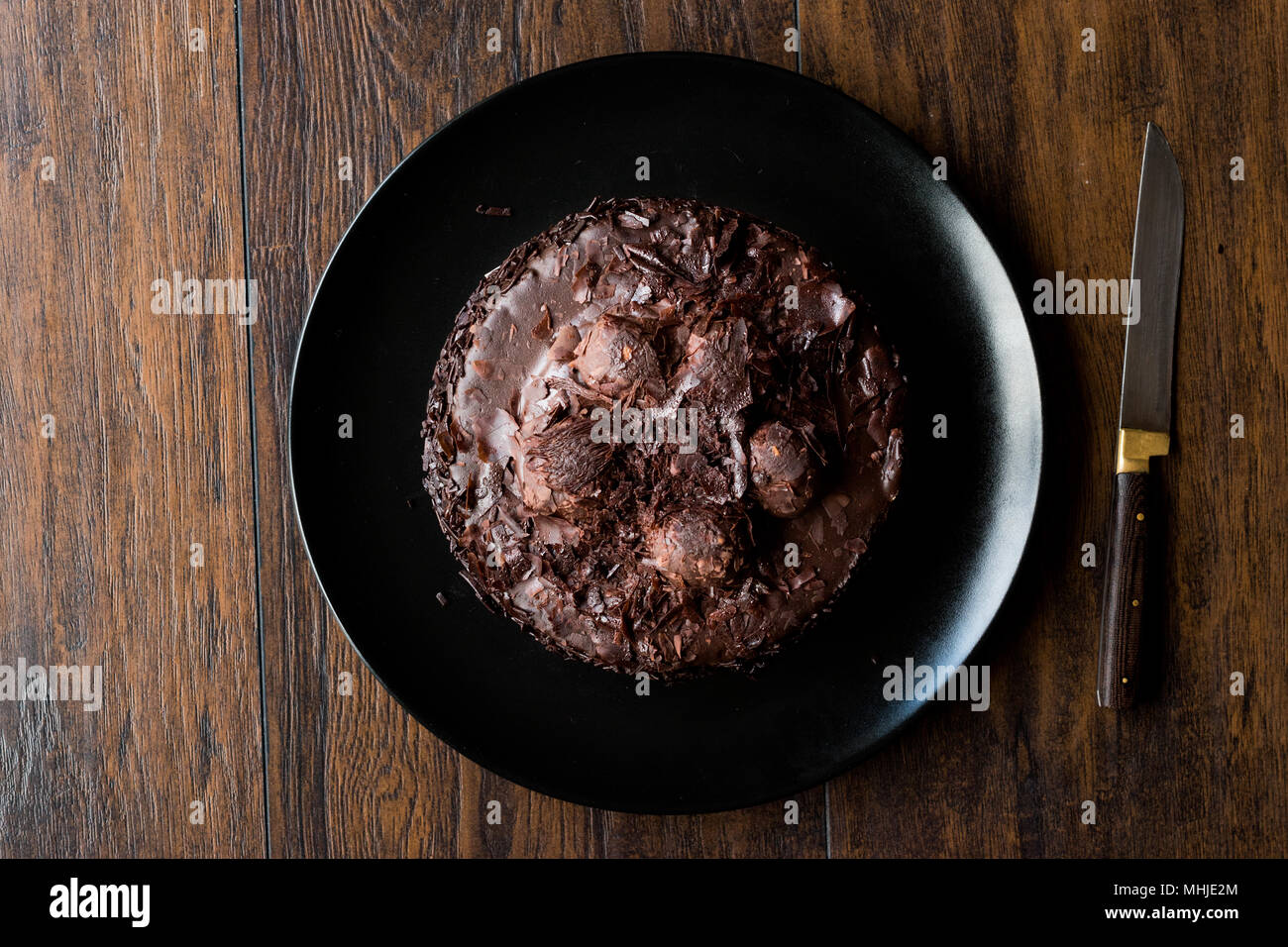 Chocolate Profiterole Cake on Black Plate. Dessert Concept. Stock Photo