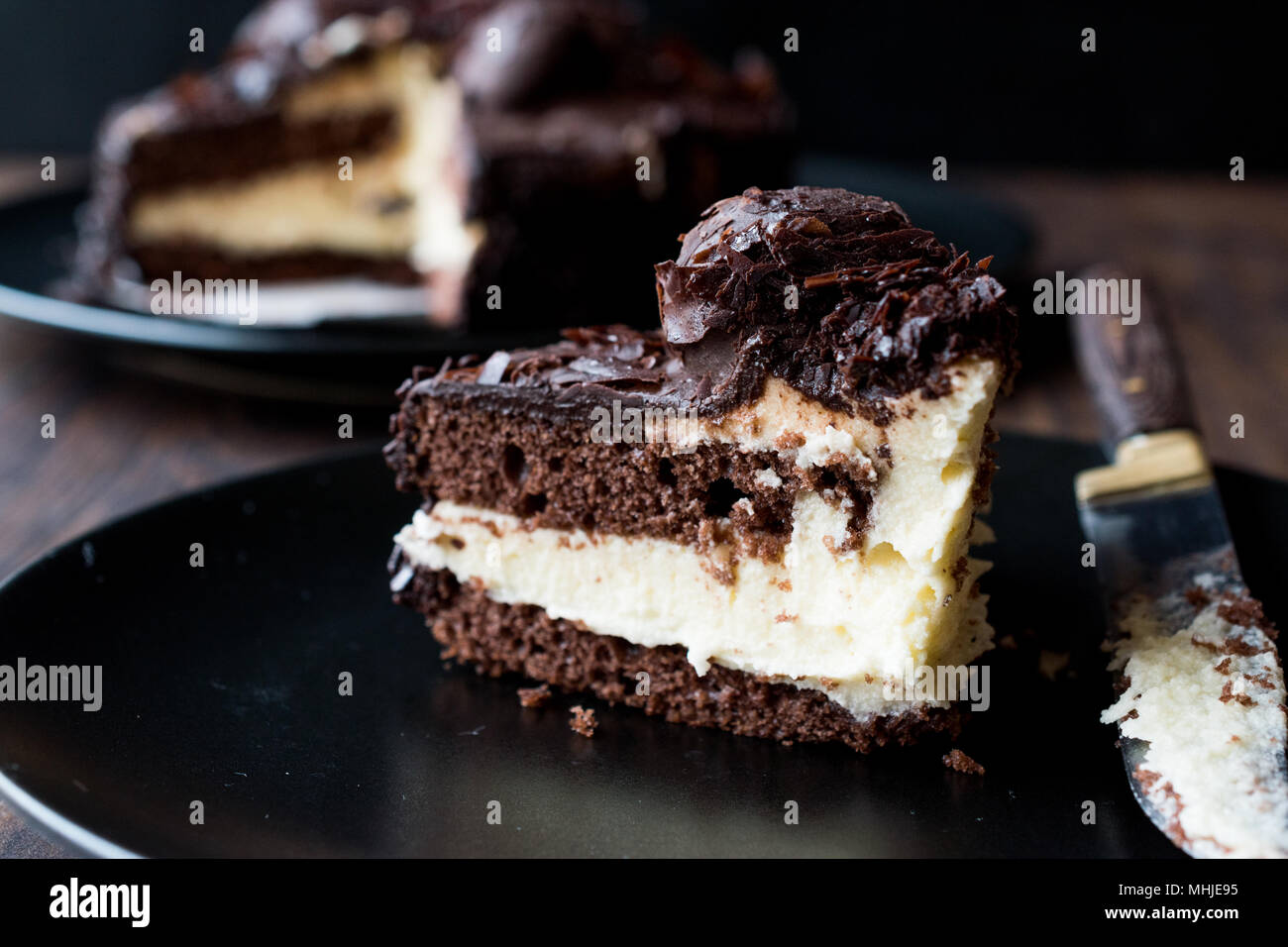 Chocolate Profiterole Cake on Black Plate. Dessert Concept. Stock Photo