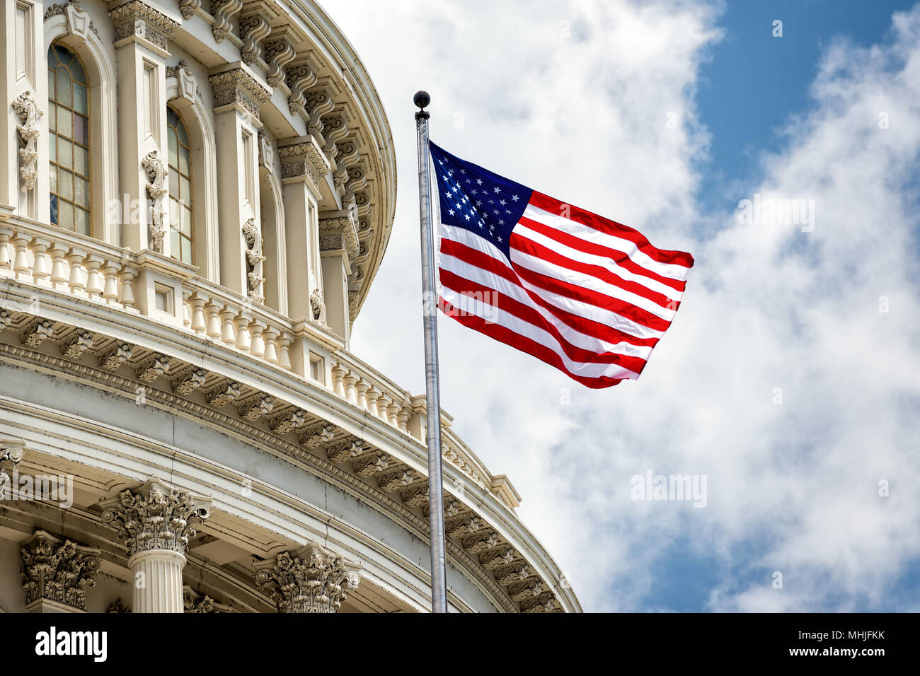 Washington DC Capitol dome detail with waving american flag Stock Photo ...