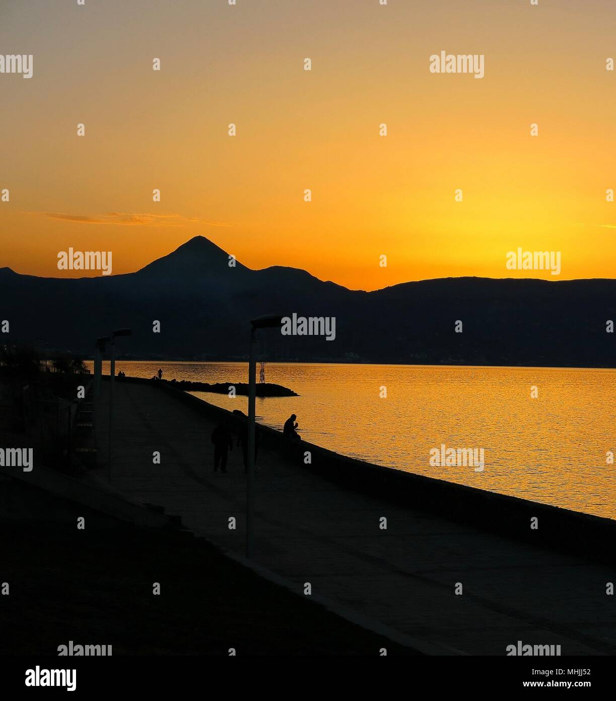 Sun  setting behind the mountains. Stock Photo