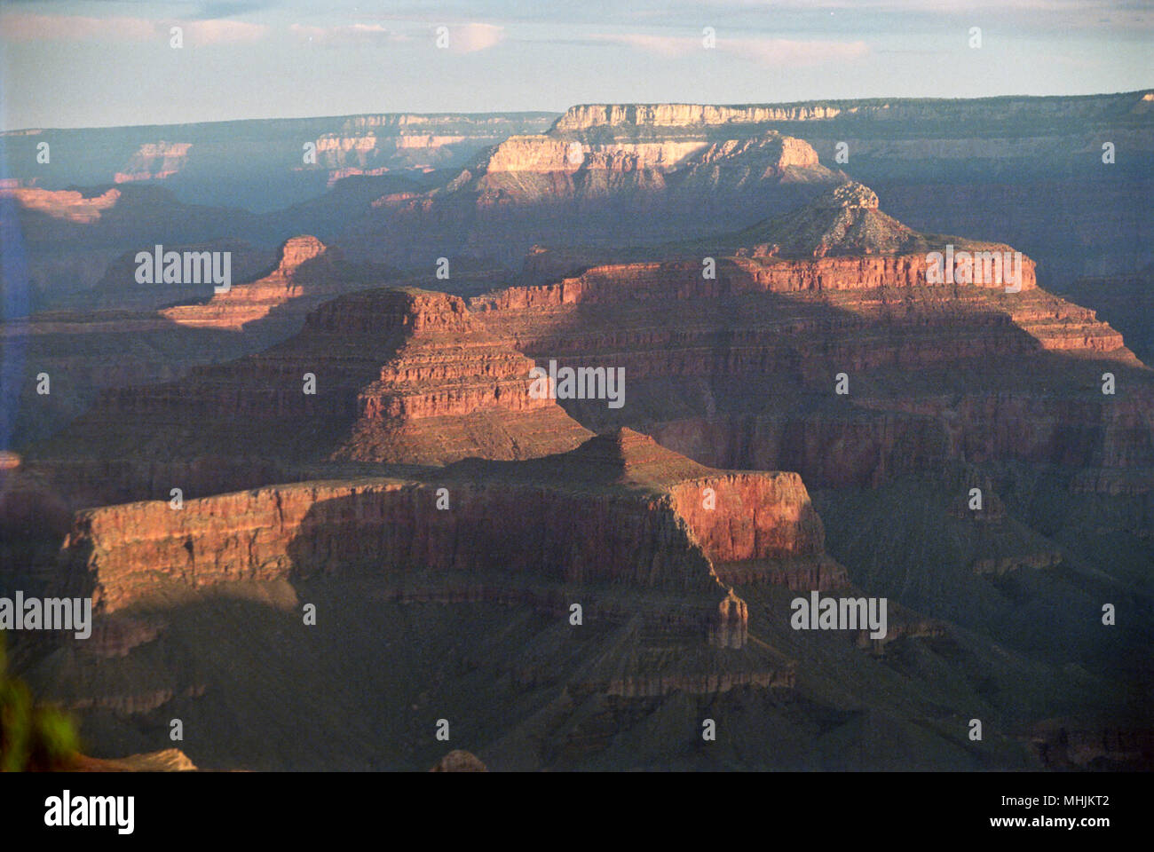 Sunset paints the buttes and bluffs of the Grand Canyon in dramatic reds and oranges. Stock Photo