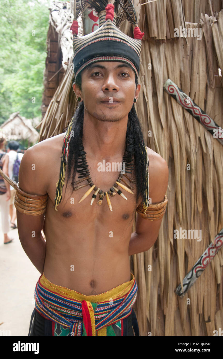 Young tribesman greets visitors to the Murut Longhouse at the Mari Mari Cultural Village, Kota Kinabalu, Sabah, Malaysian Borneo Stock Photo