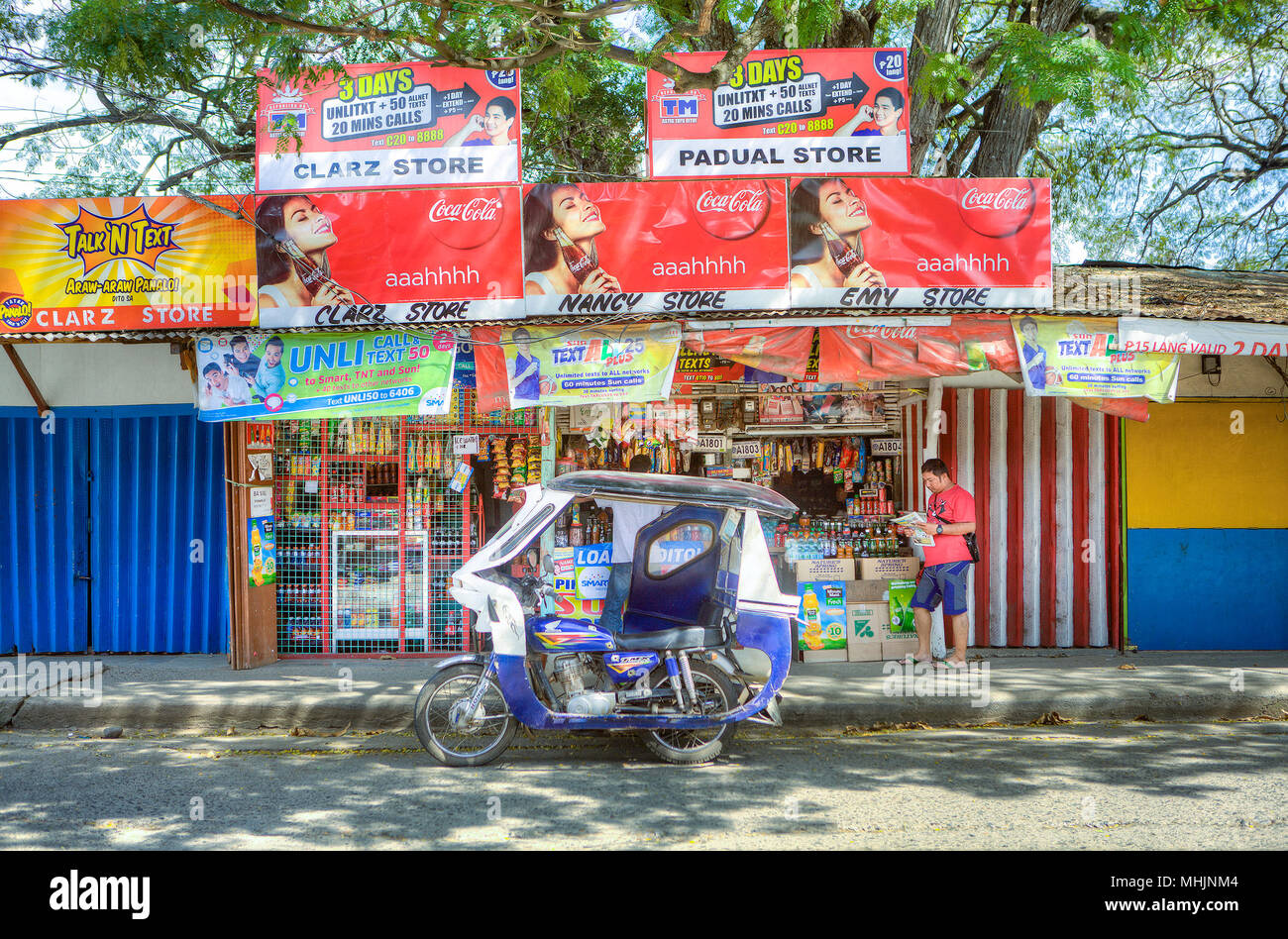 Lifestyle in a Filipino neighborhood at Puerto Princesa, Palawan, Philippines. Three neighborhood convenience stores (sari sari) work together to prov Stock Photo