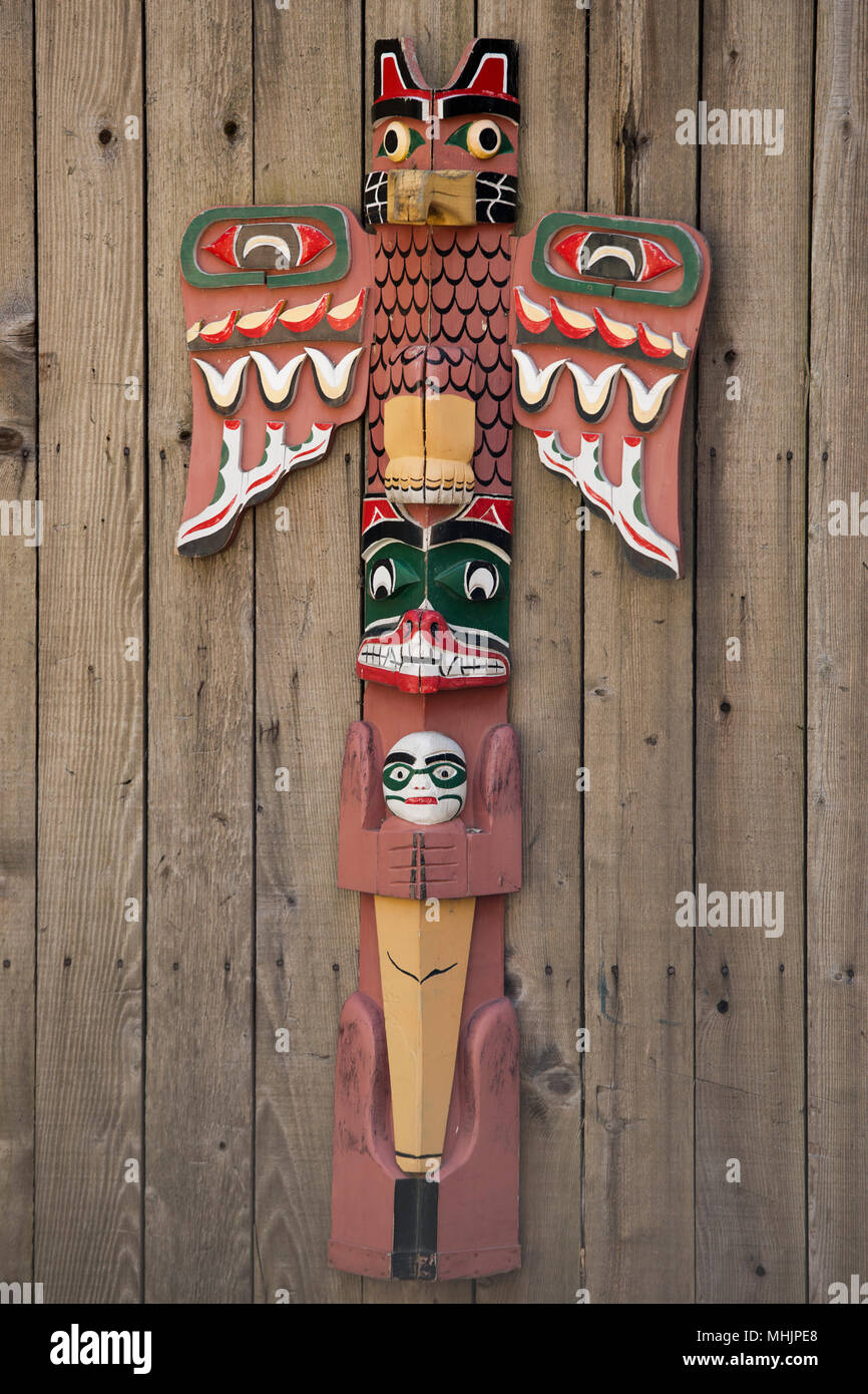 Isolated totem wood pole in the wood background Stock Photo - Alamy
