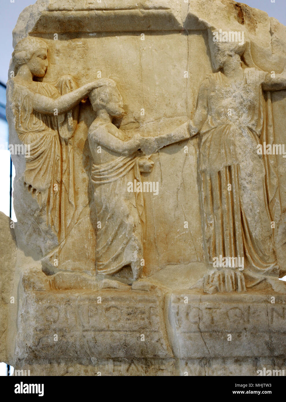 Honorary decree for Proxenides of Knidos. The Athenians bestow on Proxenidos, son of Proxenos, the title of proxemos (consul) and benefactor. Relief depicting the honoree stands between Athena, who offers him a wreath, and Aphrodite, who introduces him to Athena. Detail. Ca. 420 BC. Acropolis Museum. Athens. Greece. Stock Photo