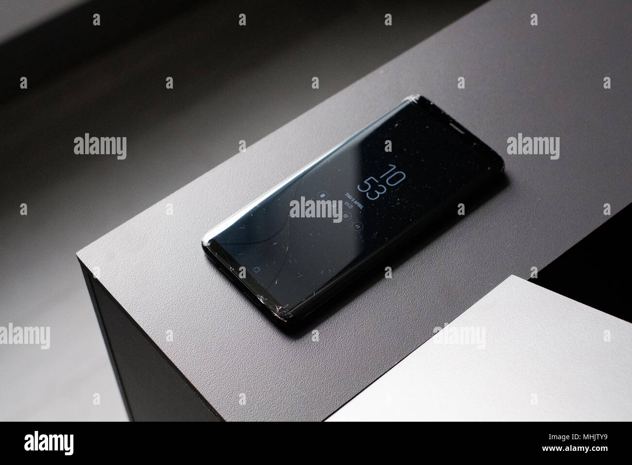 RIGA, APRIL 2018 - A smashed recently launched Samsung Galaxy S9 Plus smartphone with cracked screen is displayed for editorial purposes Stock Photo