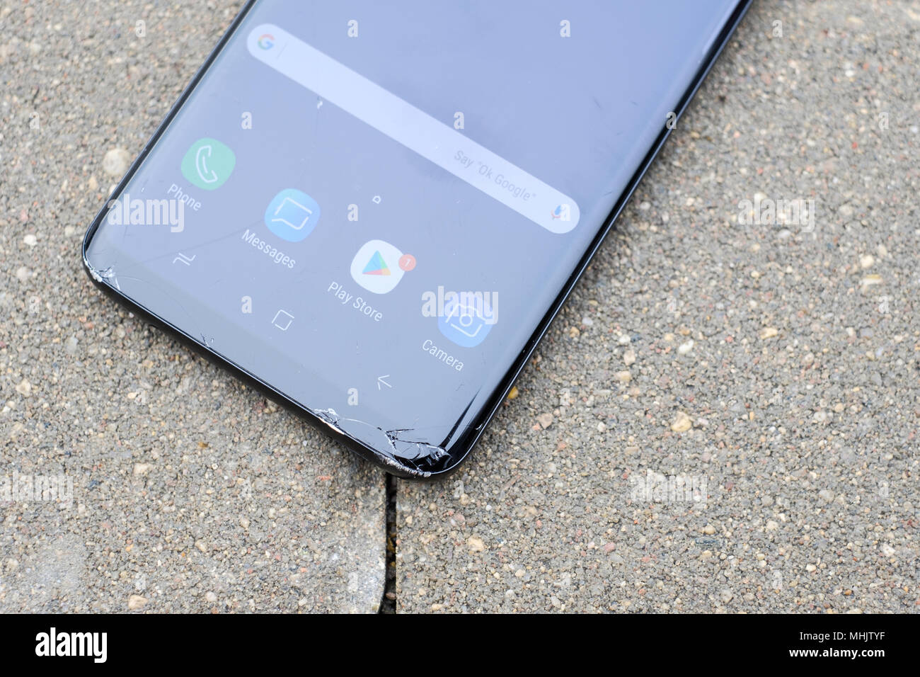 RIGA, APRIL 2018 - A smashed recently launched Samsung Galaxy S9 Plus smartphone with cracked screen is displayed for editorial purposes Stock Photo