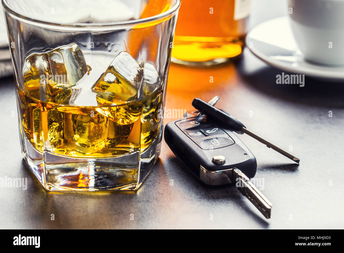 Car keys and glass of alcohol on table in pub or restaurant. Stock Photo