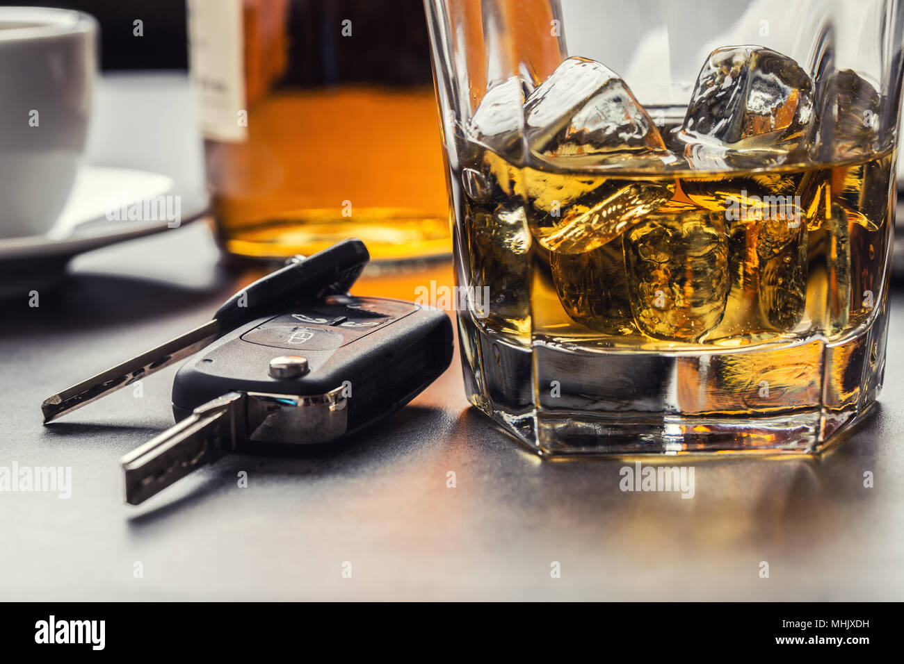 Car keys and glass of alcohol on table in pub or restaurant. Stock Photo
