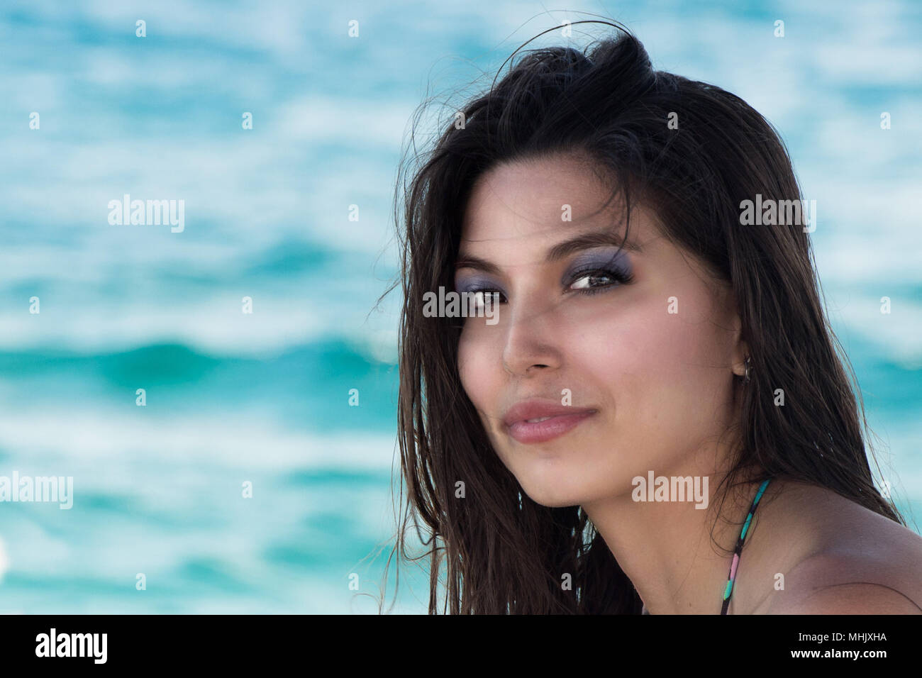 https://c8.alamy.com/comp/MHJXHA/beautiful-black-hair-lady-latina-mexican-woman-on-the-sea-background-looking-at-you-lovely-MHJXHA.jpg