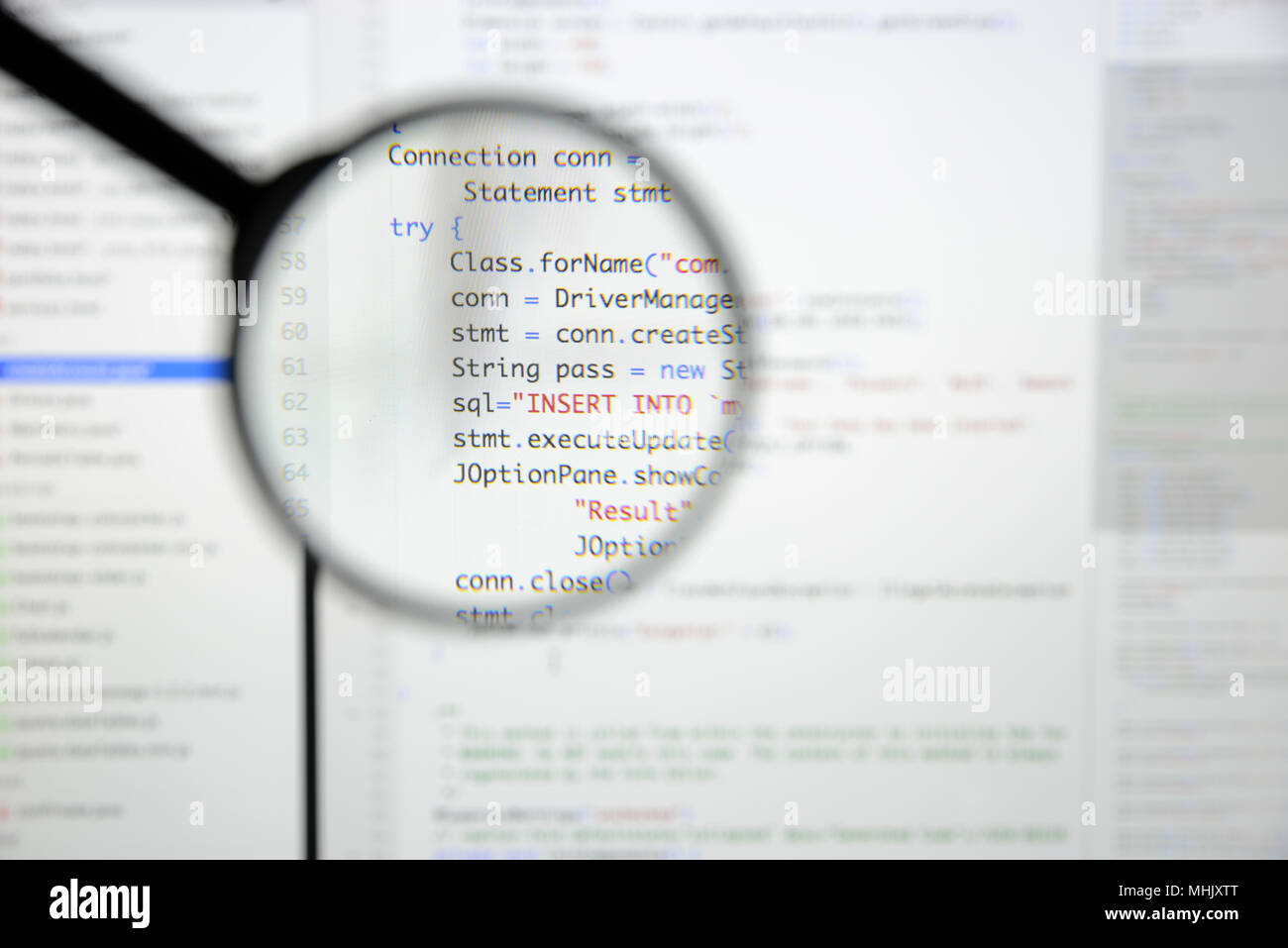 Real Java code developing screen. Programing workflow abstract algorithm concept. Lines of Java code visible under magnifying lens. Stock Photo