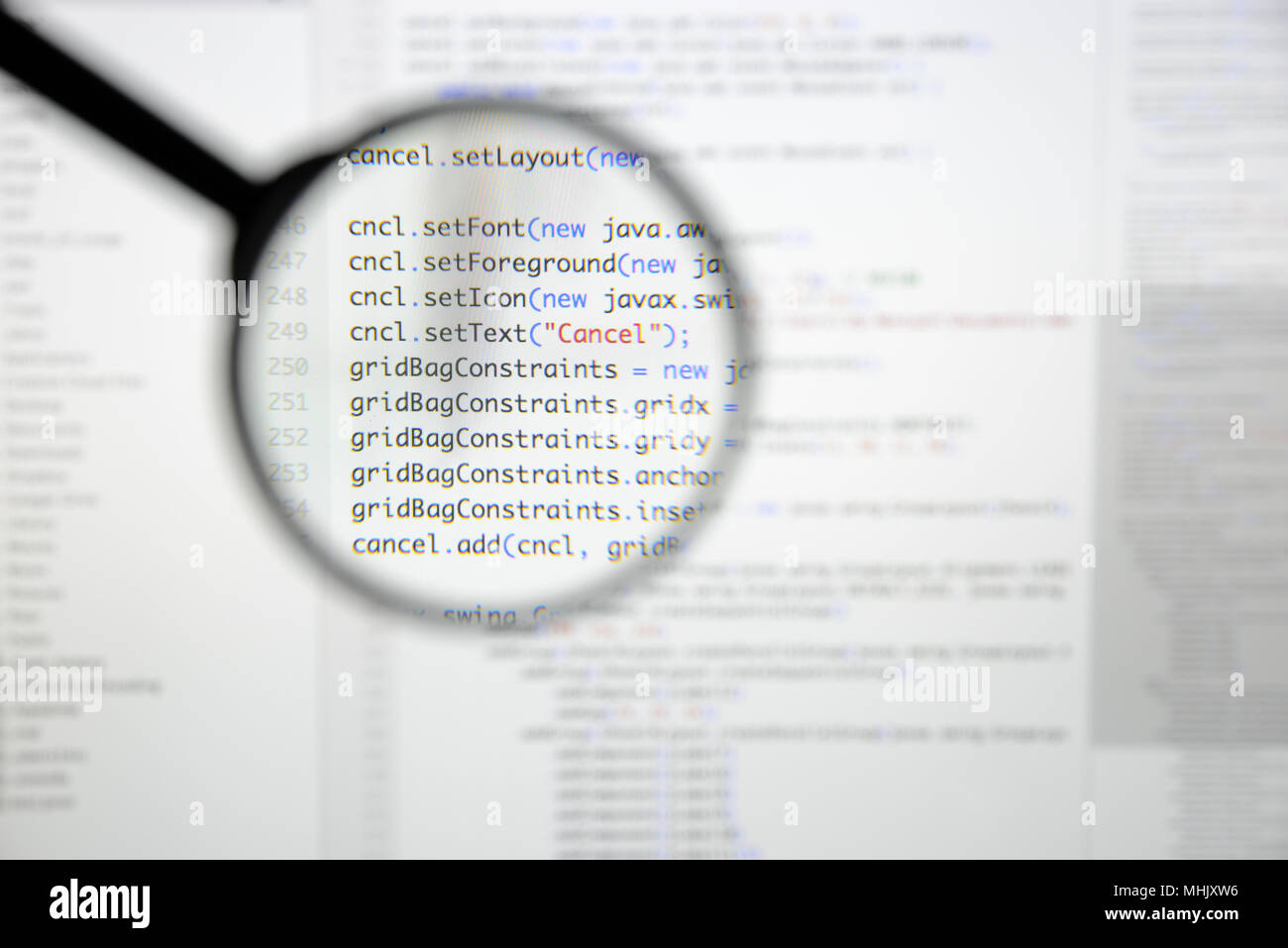 Real Java code developing screen. Programing workflow abstract algorithm concept. Lines of Java code visible under magnifying lens. Stock Photo