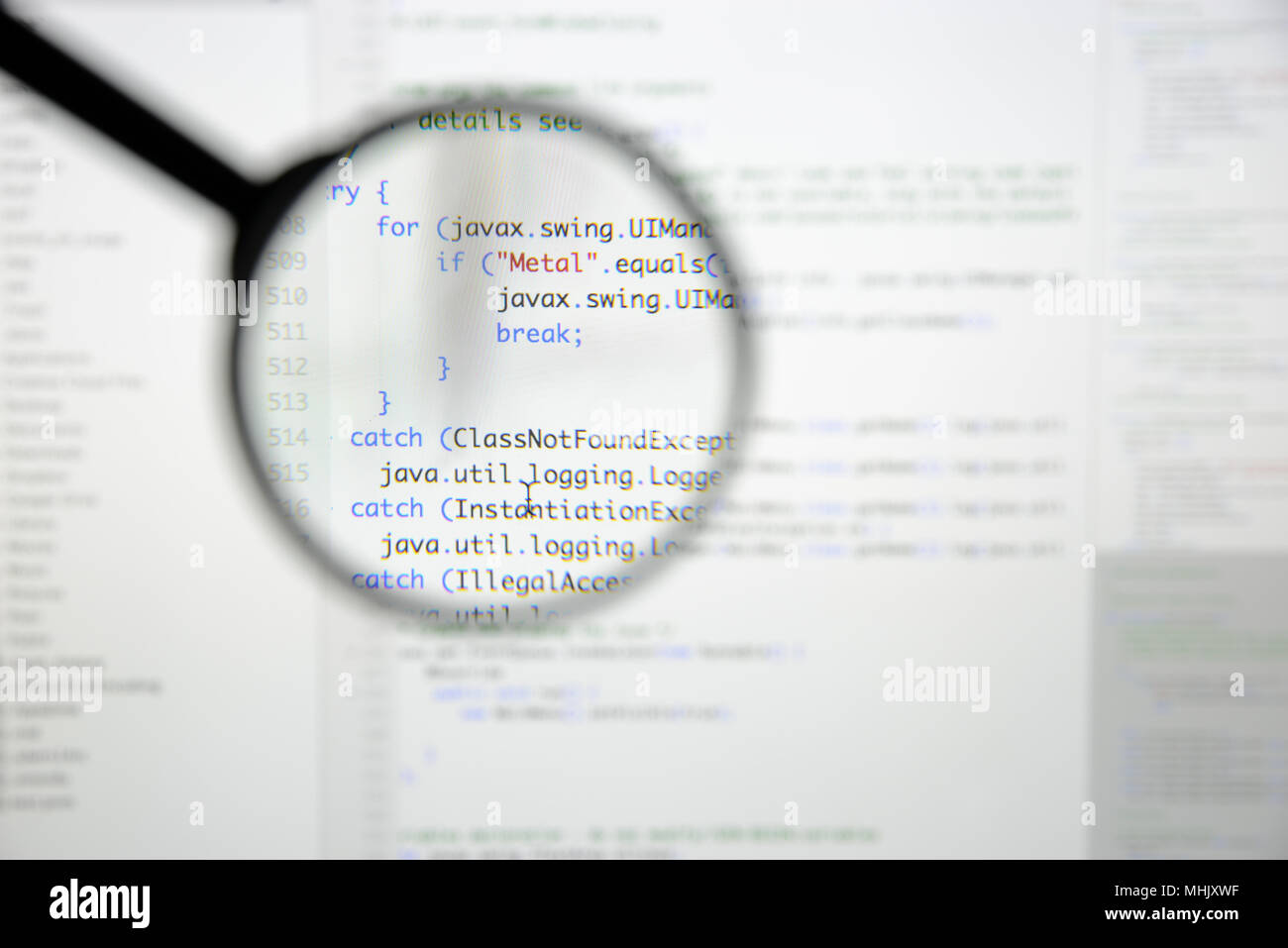 Real Java code developing screen. Programing workflow abstract algorithm concept. Lines of Java code visible under magnifying lens. Stock Photo