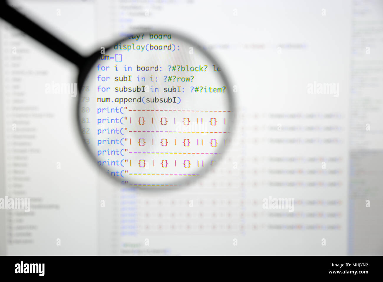 Real Python code developing screen. Programing workflow abstract algorithm concept. Lines of Python code visible under magnifying lens. Stock Photo