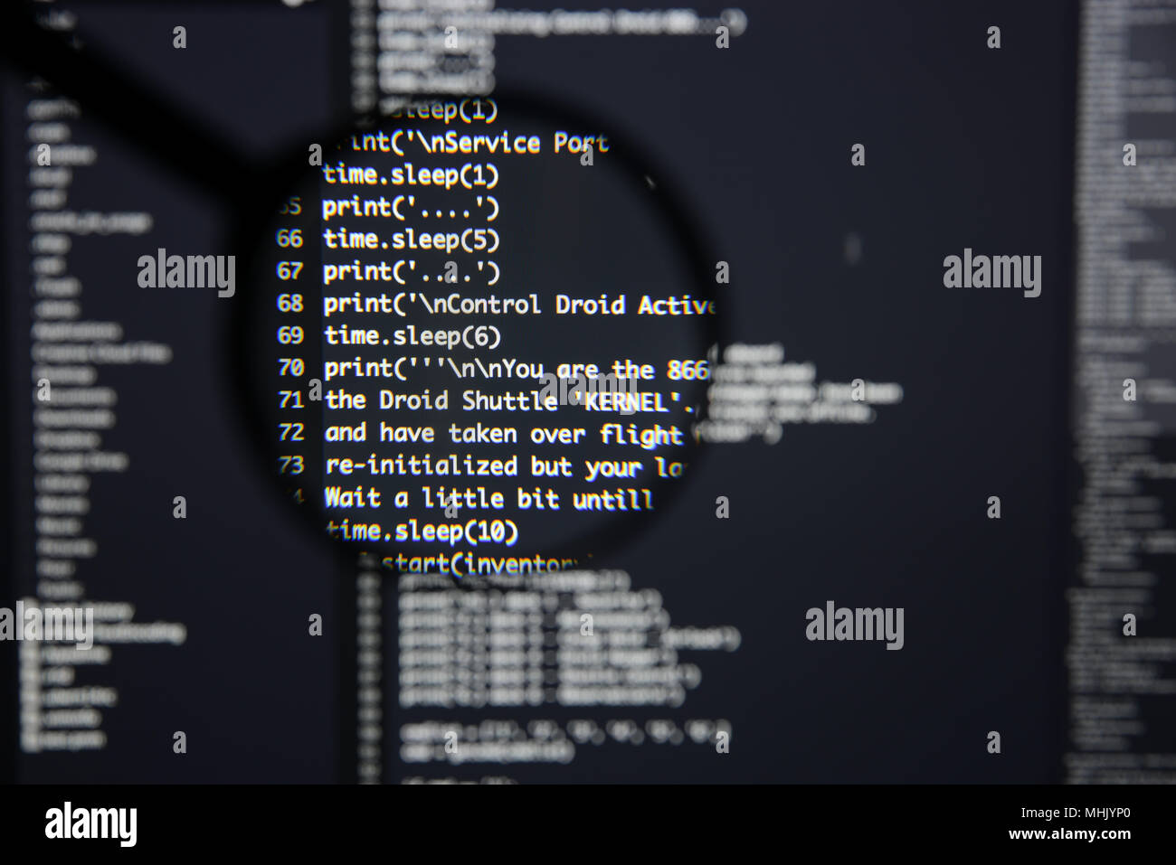 Real Python code developing screen. Programing workflow abstract algorithm concept. Lines of Python code visible under magnifying lens. Stock Photo