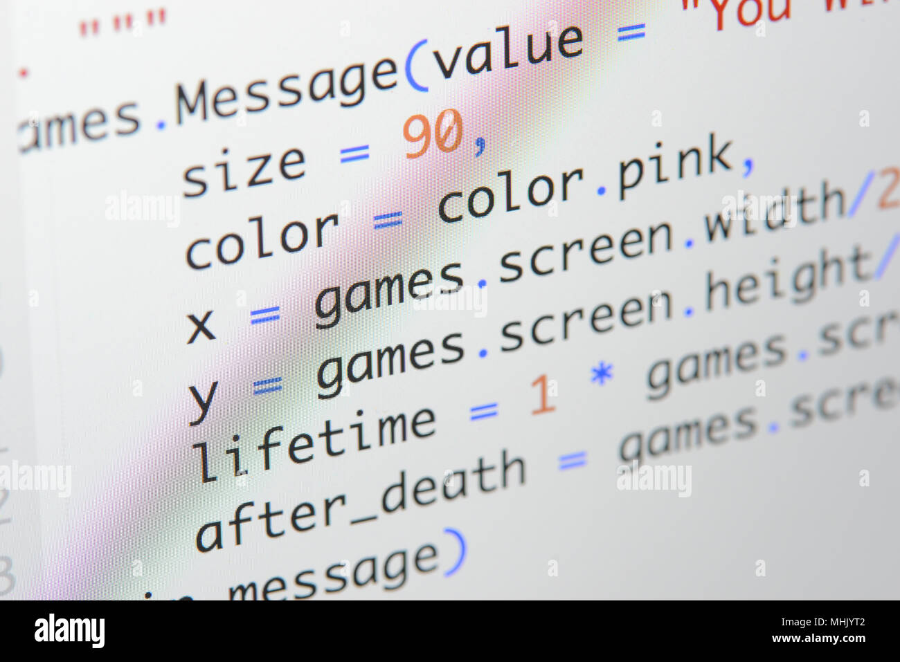 Real Python code developing screen. Programing workflow abstract algorithm concept. Lines of Python code visible under magnifying lens. Stock Photo