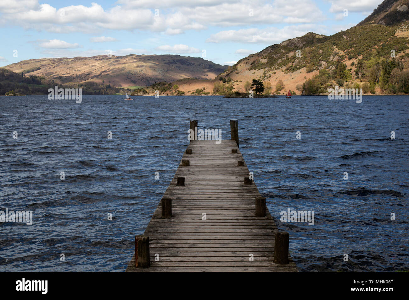 A jetty on the shore of Ullswater, one of the lakes in the Lake District National Park in England. Stock Photo
