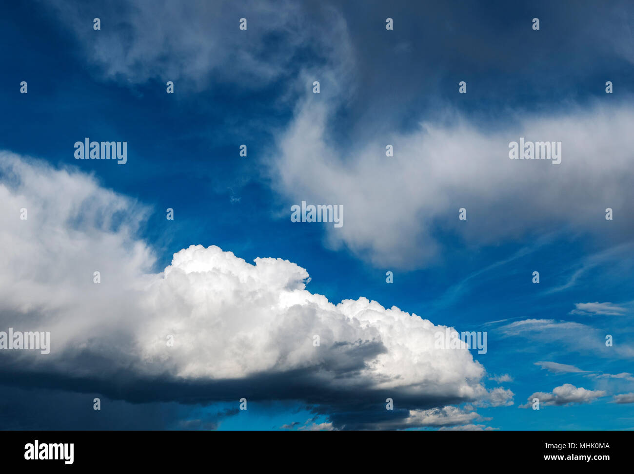 Cumulus clouds against a clear blue Colorado sky Stock Photo