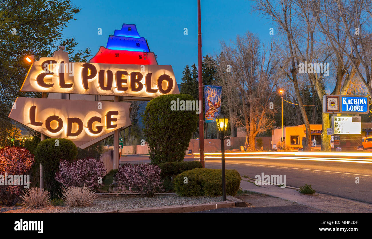 Vintage neon motel signs and traffic light streaks at night on main street in Taos, New Mexico, USA. Stock Photo