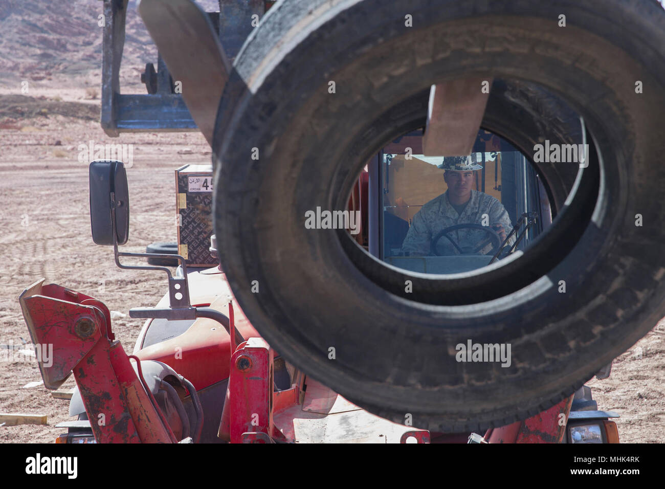 U.S. Marine Lance Cpl. Elias Damian, Electrician with Marine Wing Support Squadron 373, Special Purpose Marine Air-Ground Task Force – Crisis Response – Central Command picks up tires with a forklift aboard Camp Titin, Jordan Mar. 15, 2018. The Marines are building a live-fire range in support of exercise Eager Lion 18, a bi-lateral training event designed to exchange military expertise and improve interoperability with the U.S. military and Jordan Armed Forces. Stock Photo