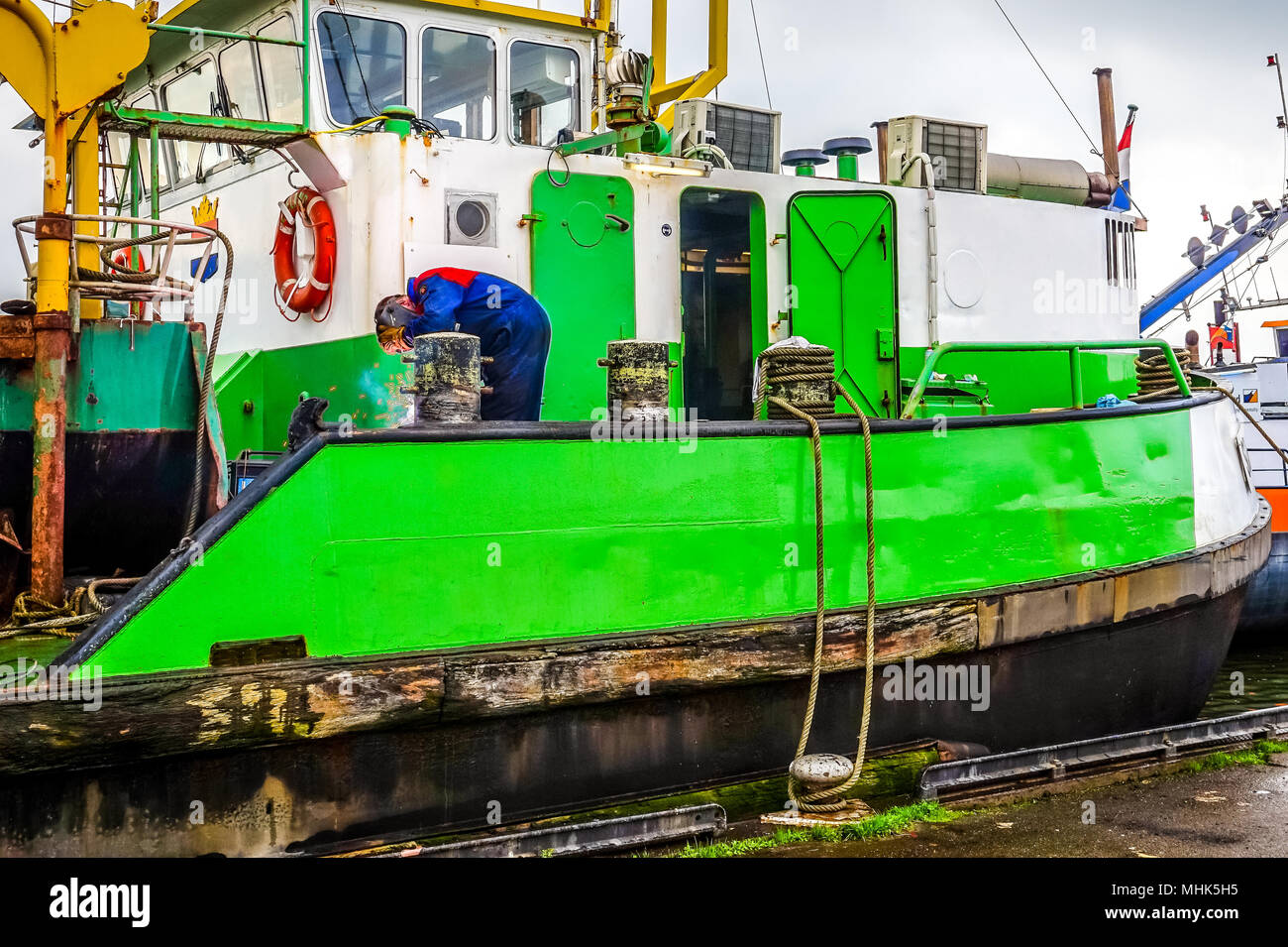 Maintenance done on a dredger in the Dutch harbor of the fishing