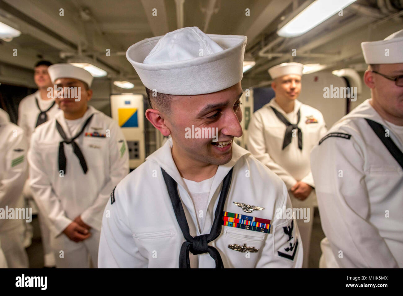 NORFOLK, Va. (March 20, 2018) Aviation Ordnanceman 3rd Class Julio Pino laughs after a service dress white uniform inspection aboard the aircraft carrier USS George H.W. Bush (CVN 77). The ship is in port in Norfolk, Virginia, conducting sustainment exercises to maintain carrier readiness. (U.S. Navy Stock Photo