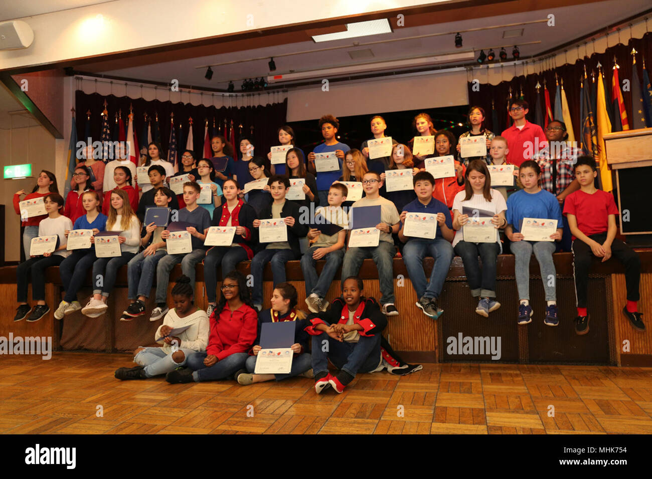 Students from Zama American Middle-High School Drama and Chorus Class receive a certificate of appreciation for their performance during the Women's History Month Observance held March 23 in the Camp Zama Community Club. (U.S. Army Stock Photo