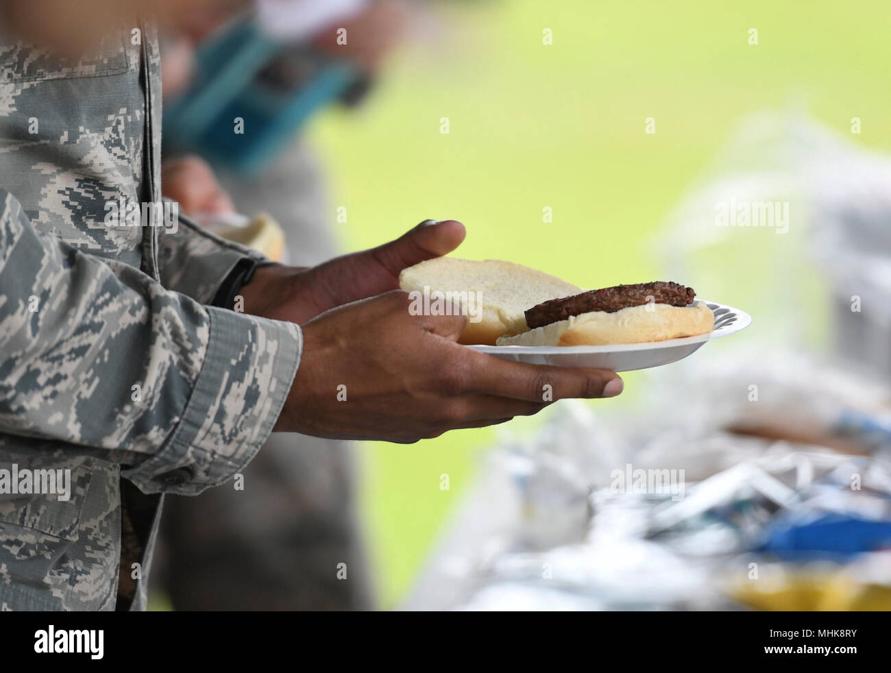 U.S. Air Force Staff Sgt. Tony Galloway, 81st Diagnostic and Therapeutics Squadron radiology technician, holds a plate of food during the Air Force Assistance Fund burger burn at the Crotwell Track March 26, 2018, on Keesler Air Force Base, Mississippi. The AFAF is an annual effort to raise funds for charitable affiliates that provide support to our Air Force family in need. (U.S. Air Force Stock Photo