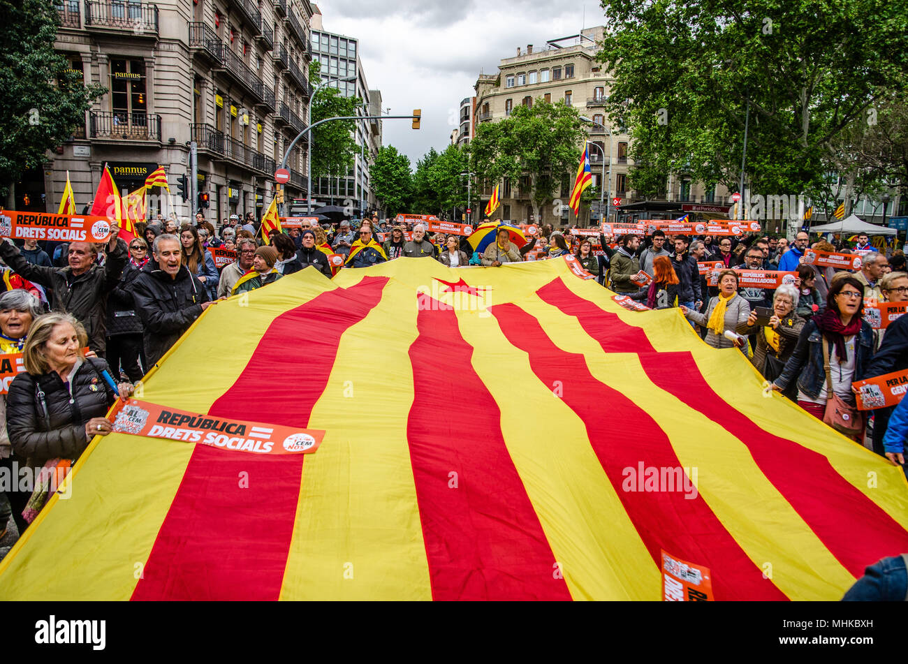 A great Catalan flag unfolds during the independence demonstration for the Republic and Social Rights. The Catalan independence movement has joined the May Day demonstrations, workers' day. Under the slogan For the Republic and social rights, hundreds of people have demonstrated in the center of Barcelona Stock Photo
