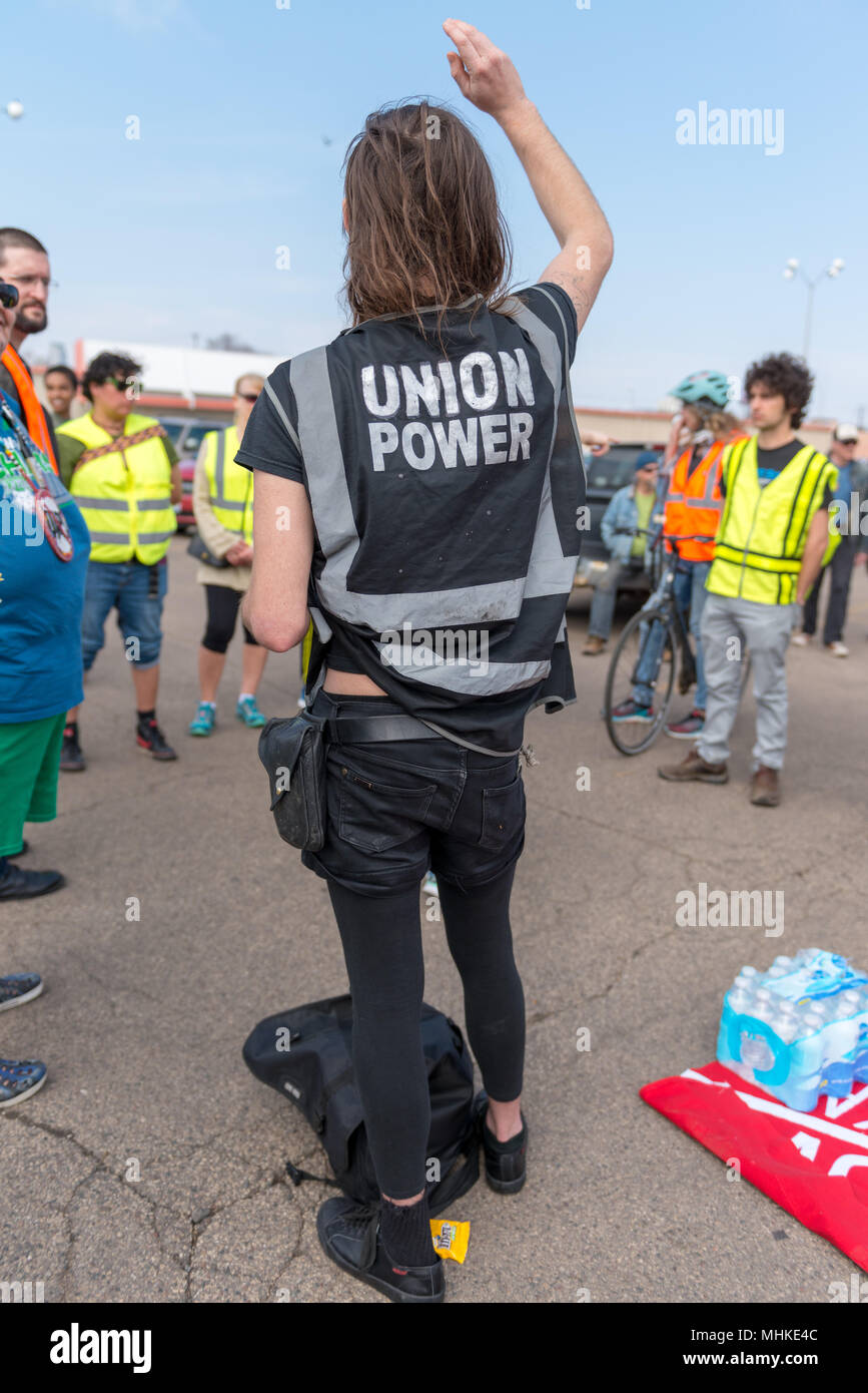 MINNEAPOLIS - May 1: A trans rights activist, wearing a vest reading 'union power,' waits for the International Workers’ Day March, hosted by a number of community organizations and labor unions. Credit: Nicholas Neufeld/Alamy Live News Stock Photo