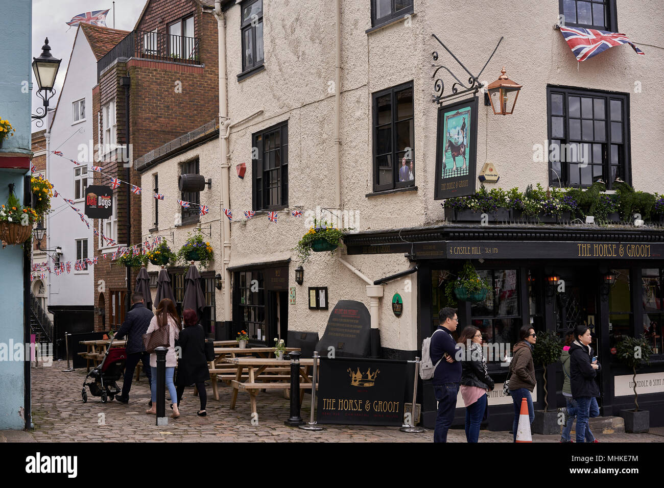 24 April 2018, Windsor, Great Britain: Passangers walking by the Pub 'The Horse and Groom' accross the Windsor Palace. Prince Harry and American Actress Meghan Markle will be saying their Wedding Vows on May 19, 2018 at the Windsor Palace. Photo: David Azia/dpa Stock Photo